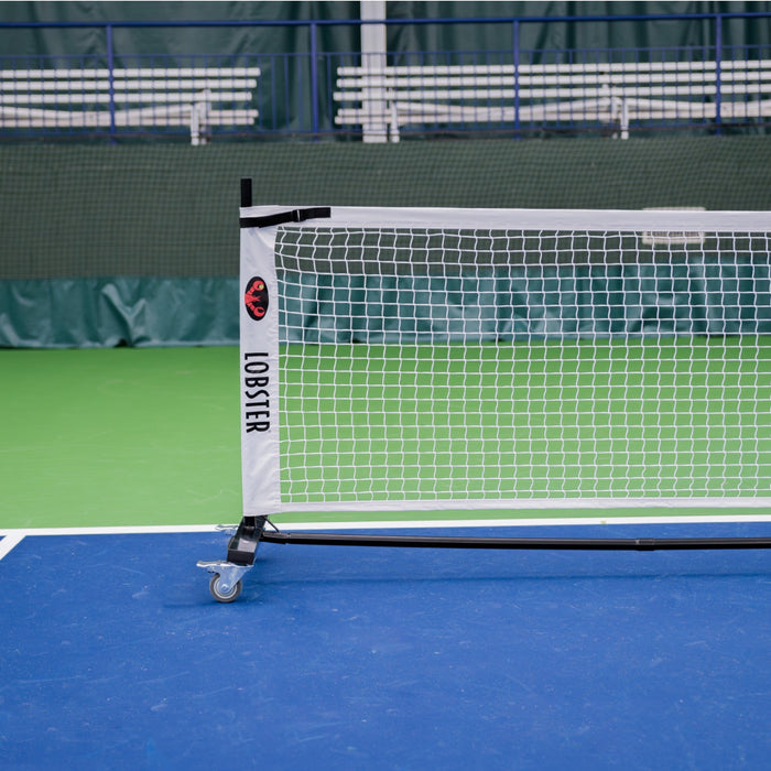 Lobster portable pickleball net frame and wheels on court