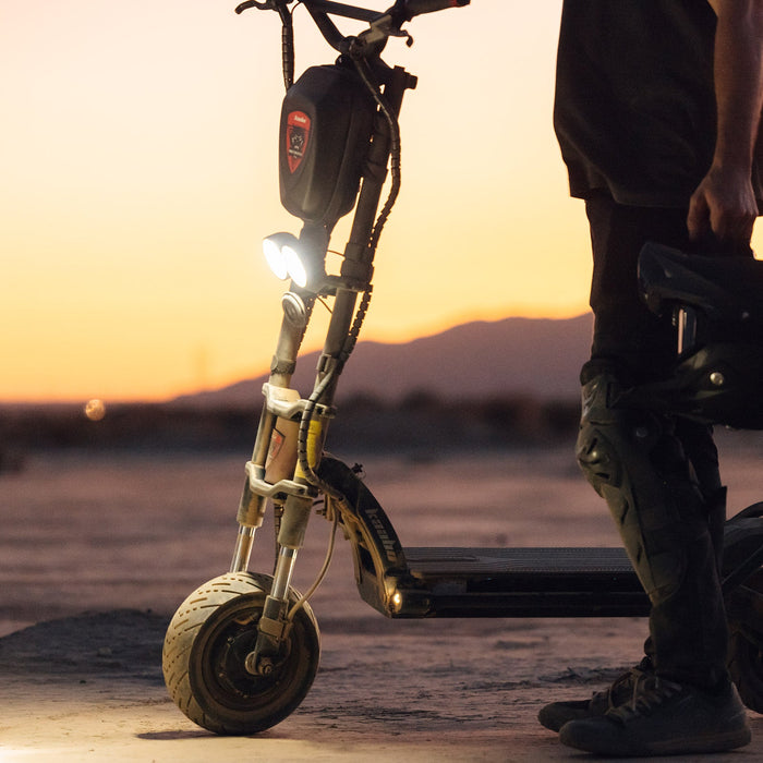Kaabo Warrior 11 Pro+ electric scooter with dual LED headlights illuminated during evening off-road ride