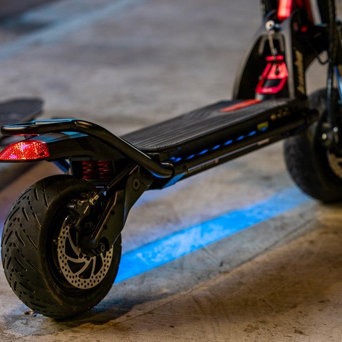 Kaabo Warrior 11 Pro+ electric scooter under-deck LED lighting with rear wheel and brake system visible at night
