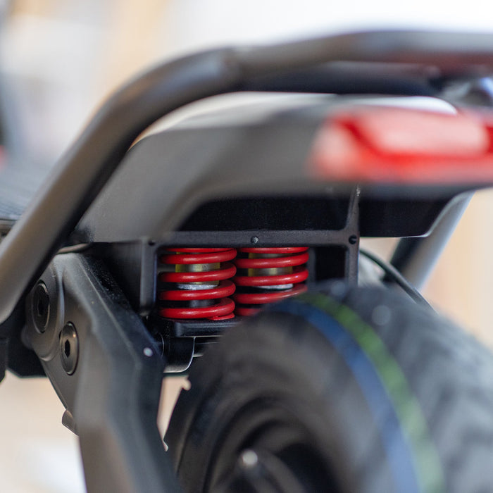 Kaabo Warrior 11 Pro+ dual rear suspension system with heavy-duty coil springs and all-terrain tire