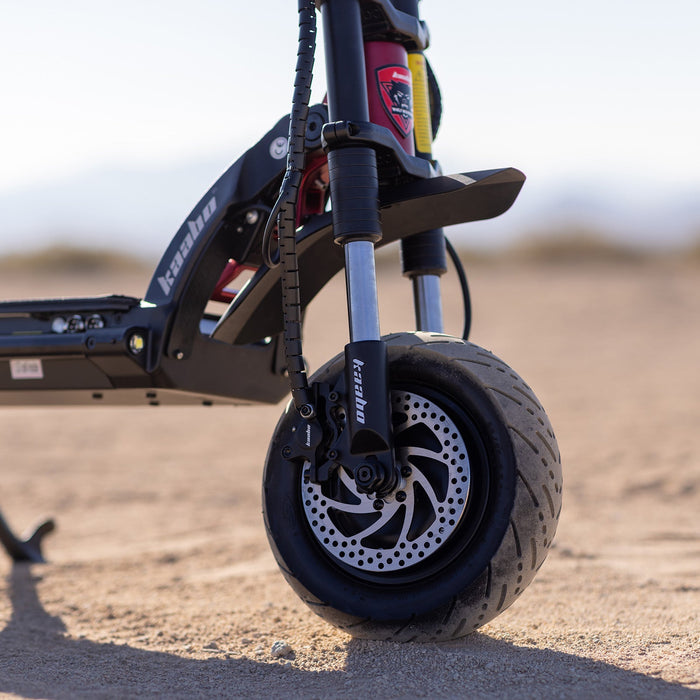 Close-up of Kaabo Warrior 11 Pro+ hydraulic front and rear suspension designed for off-road stability