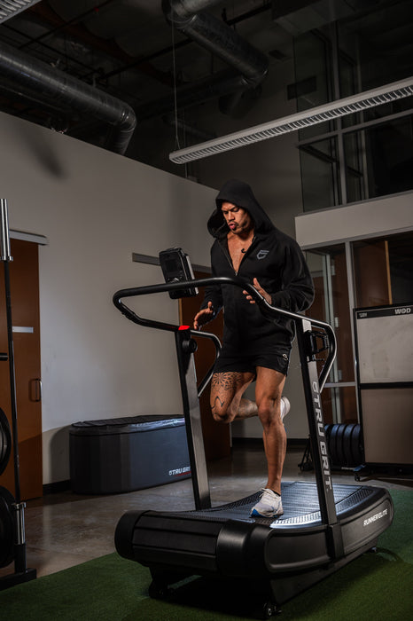 Grit Runner Elite curved treadmill in a home gym