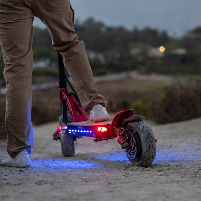 Kaabo Mantis 10 Lite electric scooter rear view at night with LED deck lighting and brake light illuminated