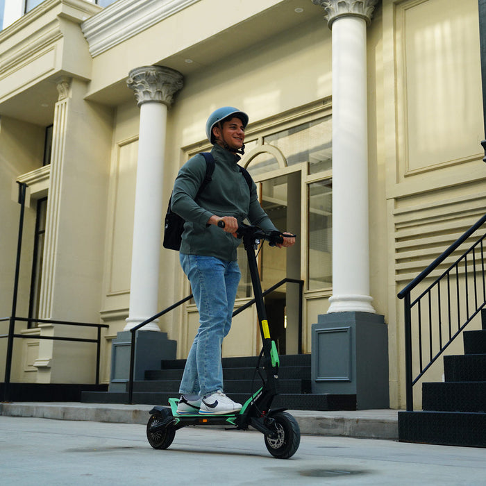 Person riding Kaabo Urban e-scooter through city streets