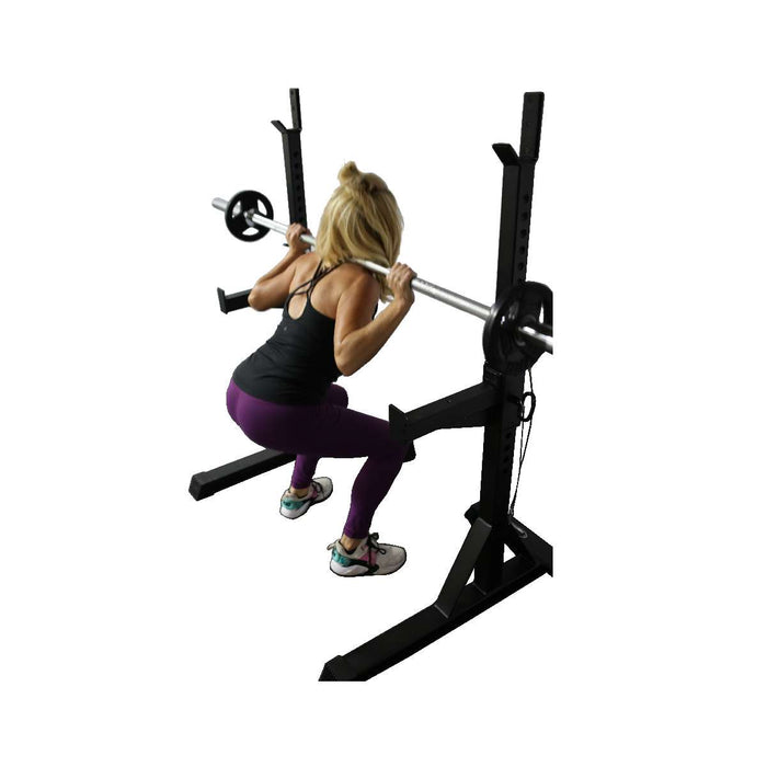 Paradigm SQST Portable Squat Stands with Spotters and J-Cups - model performing a barbell back squat