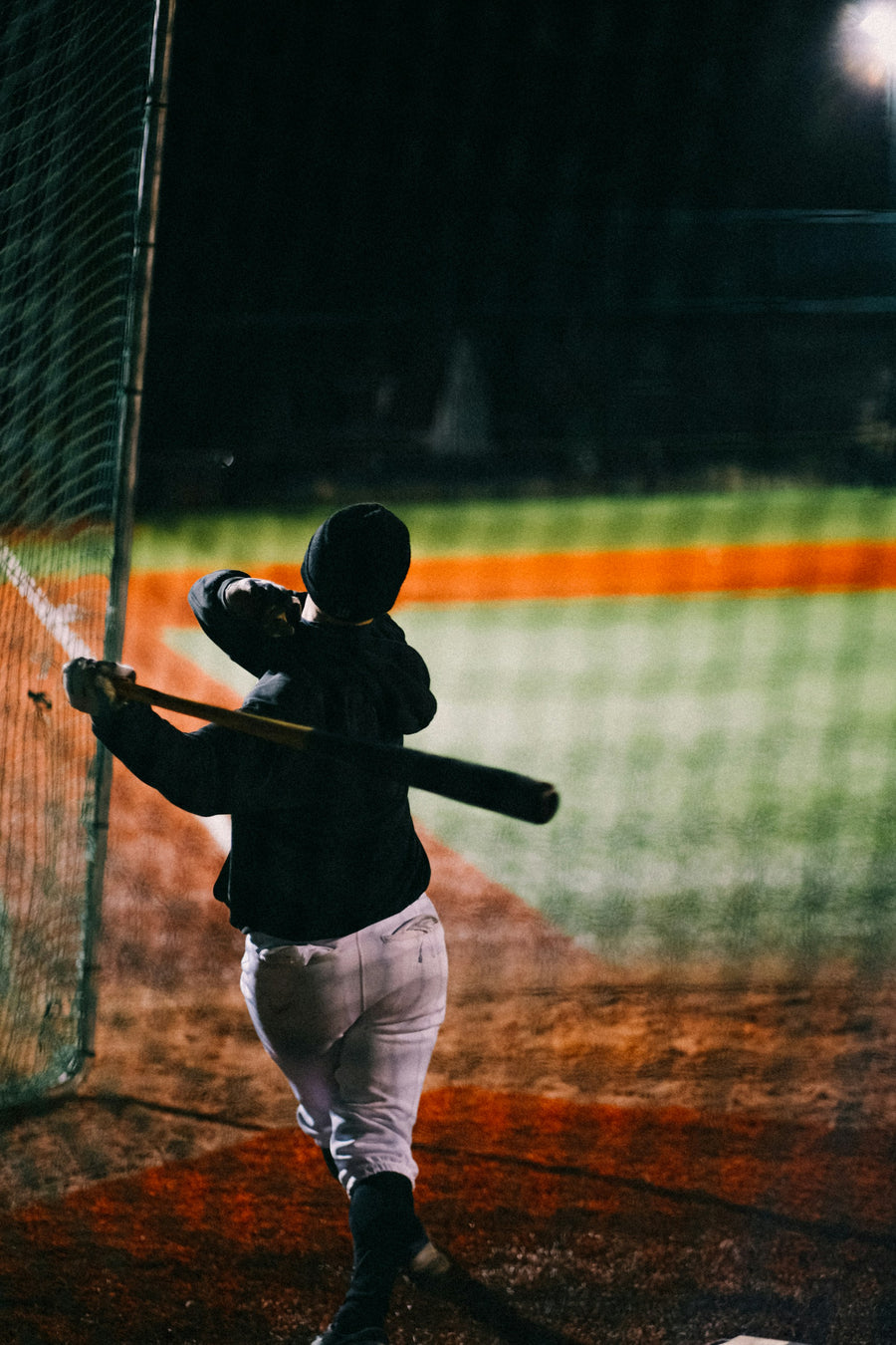 Baseball hitter waiting for a pitch in a batting cage