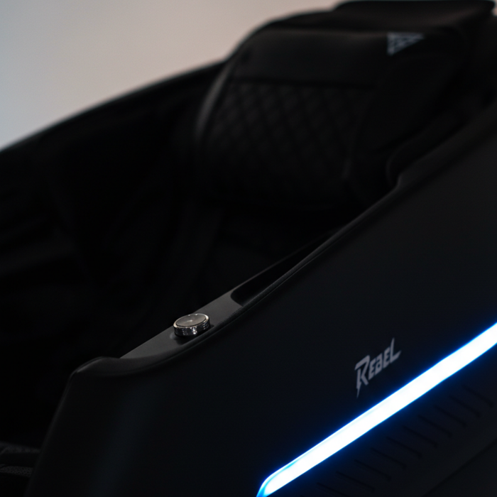 Rebel 4D massage chair close-up of the black upholstery and blue LED accents